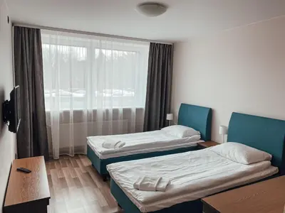 a hotel room with two beds and a window at 