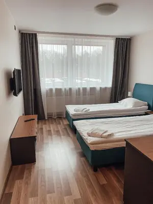 a room with two beds and a window at 