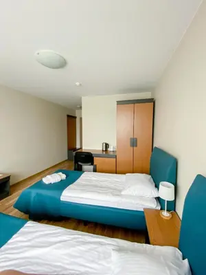 a hotel room with two beds and a desk at 