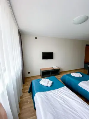 a hotel room with two beds and a television at 