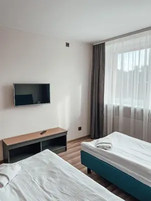 a hotel room with two beds and a flat screen tv at 