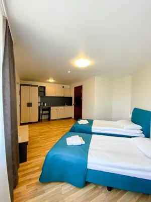 a large room with two beds and a kitchen at 