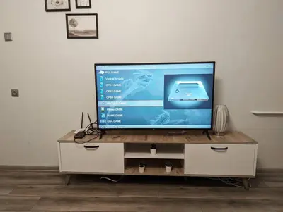 a flat screen tv sitting on top of a dresser at Scandinavian inspired design in Vilnius