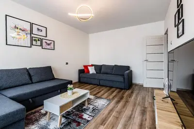 a living room with two blue couches and a table at Scandinavian inspired design in Vilnius