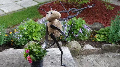 a statue of a teddy bear next to a plant at Namelis prie Magnolijos in Druskininkai