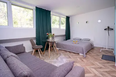 a living room with a couch and a table at House 22A Studio Apartments in Kaunas