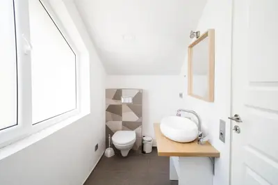 a bathroom with a sink and a toilet at House 22A Studio Apartments in Kaunas