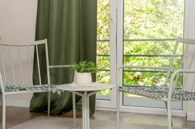 a room with two chairs and a table and a window at House 22A Studio Apartments in Kaunas