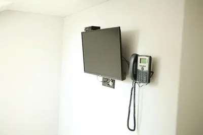 a phone is hanging on a wall at Baltas gandras in Naisiai