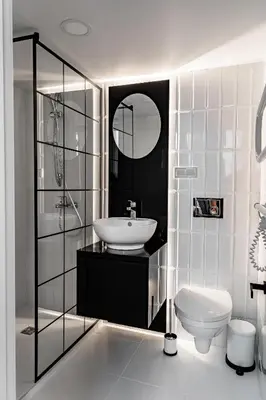 a white bathroom with a sink and a toilet at River house apartments in Kaunas