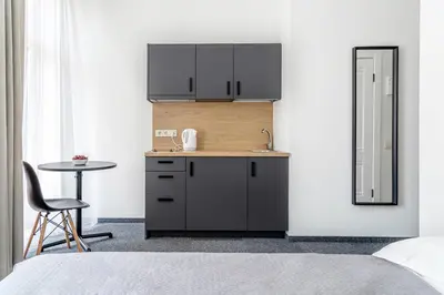 a small kitchen with a sink and a table at River house apartments in Kaunas