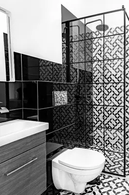a black and white bathroom with a toilet and a sink at River house apartments in Kaunas