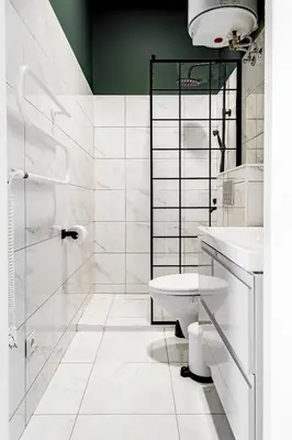 a white bathroom with a toilet and a sink at River house apartments in Kaunas