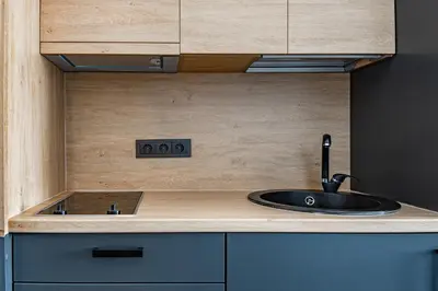 a kitchen with a sink in a wooden counter top at River house apartments in Kaunas