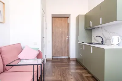 a living room with a pink couch and a table at River house apartments in Kaunas