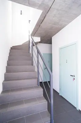 a staircase in a house with a blue door at House 22A Apartments in Kaunas