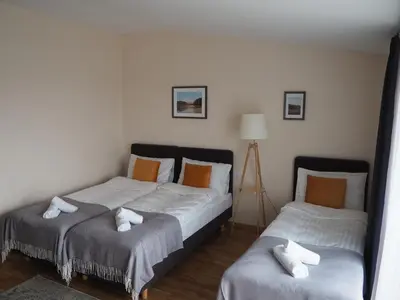 a bedroom with two beds with towels on them at Svečių namai Žara in Tytuvėnai