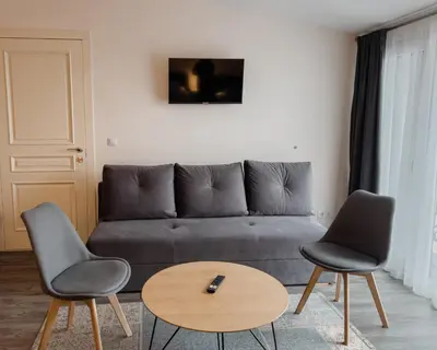 a living room with a couch and two chairs and a table at Svečių namai Žara in Tytuvėnai