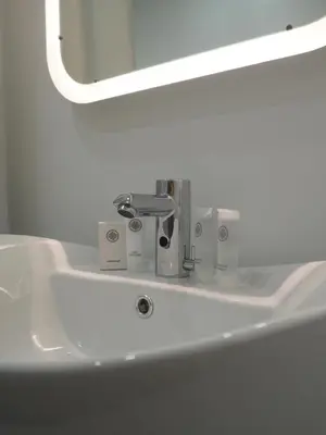 a white sink in a bathroom with a mirror at Svečių namai Žara in Tytuvėnai