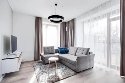 a living room with a couch and a tv at #stayhere - Central Castle View Riverside Apartment in Vilnius