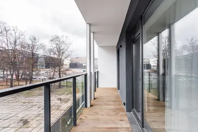 a view from the balcony of a building with glass windows at #stayhere - Central Castle View Riverside Apartment in Vilnius