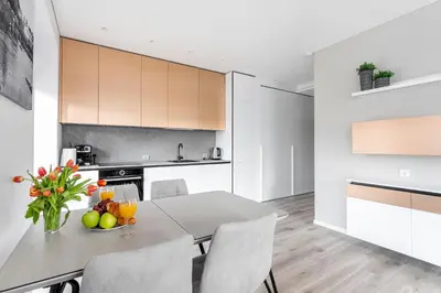 a kitchen and dining room with a table and chairs at #stayhere - Central Castle View Riverside Apartment in Vilnius