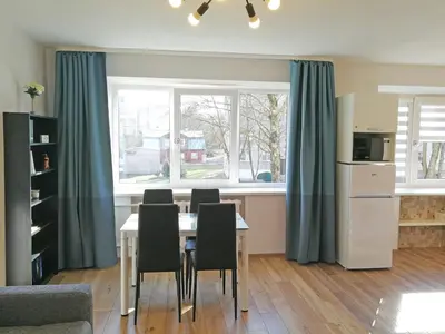 a kitchen with a table and chairs in a room at Šiauliai Central Apartment @ Trakų street in Šiauliai
