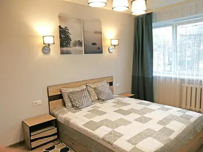 a bedroom with a bed and a window at Šiauliai Central Apartment @ Trakų street in Šiauliai