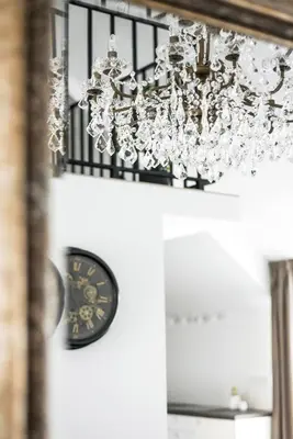 a chandelier and a clock in a room at Luxury Loft in Kaunas