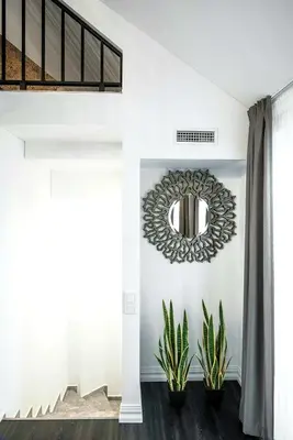 a hallway with a mirror and plants at Luxury Loft in Kaunas