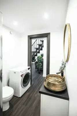 a bathroom with a washing machine and a toilet at Luxury Loft in Kaunas