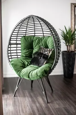 a green chair with a pillow in a room at Luxury Loft in Kaunas