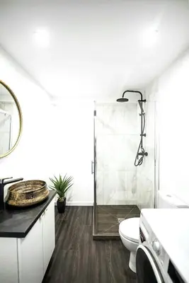 a bathroom with a toilet and a glass shower at Luxury Loft in Kaunas