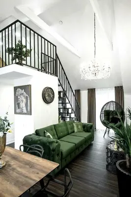 a living room with a green couch and a table at Luxury Loft in Kaunas