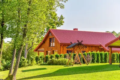 a wooden house with a yard in front of it at Vila LATO, Druskininkai in Latežeris