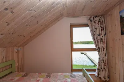 a bedroom with a bed and a large window at Vila LATO, Druskininkai in Latežeris