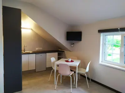 a kitchen and dining room with a table and chairs at 