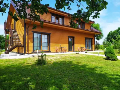 a yellow house with a lawn in front of it at 