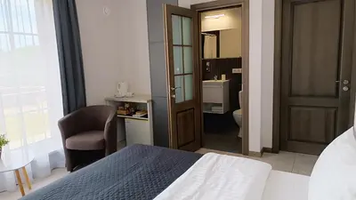 a bedroom with a bed and a chair and a bathroom at 