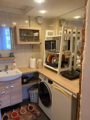 a kitchen with a washing machine and a sink at Gediminas apartment in Kaunas