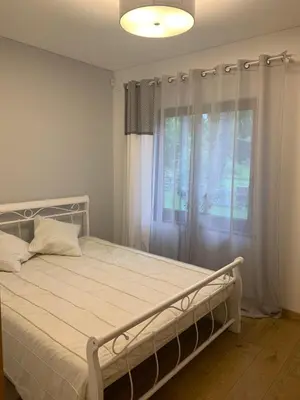a bedroom with a bed and a window with curtains at Kulautuva Rest Home Large Space in Kulautuva