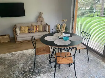a table and chairs in a living room with a couch at Kulautuva Rest Home Large Space in Kulautuva