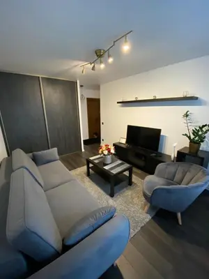 a living room with a couch and a table at Parko 443 in Panevėžys