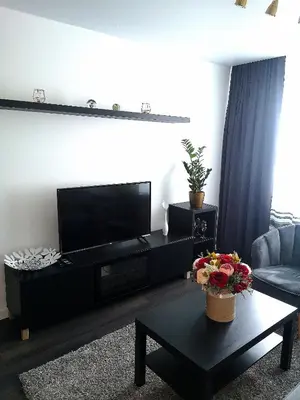 a living room with a flat screen tv on a wall at Parko 443 in Panevėžys