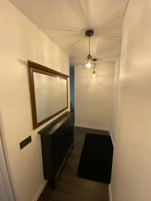 a hallway with a mirror and a dresser in a room at Parko 443 in Panevėžys