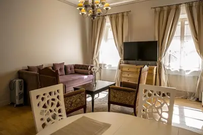 a living room with a couch and a table and chairs at Gaono apartment Free Parking in Vilnius