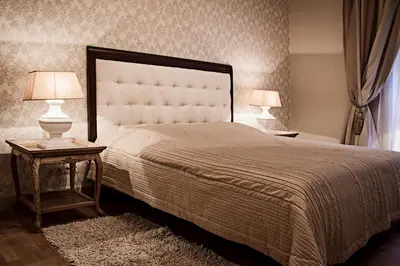 a bedroom with a large bed with two lamps on tables at Gaono apartment Free Parking in Vilnius