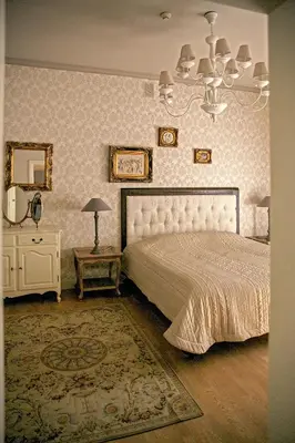 a bedroom with a bed and a chandelier at Gaono apartment Free Parking in Vilnius