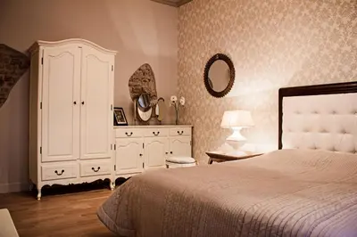 a bedroom with a large white bed and a dresser at Gaono apartment Free Parking in Vilnius