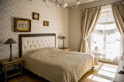 a bedroom with a large bed and a window at Gaono apartment Free Parking in Vilnius